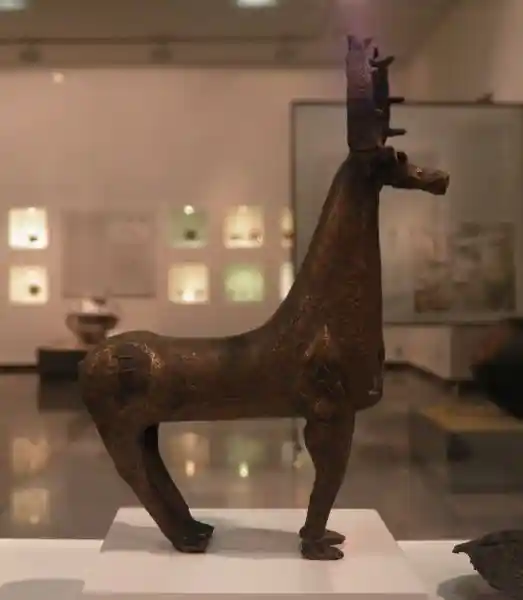 A swastika symbol on the upper part of the back legs of a deer figurine